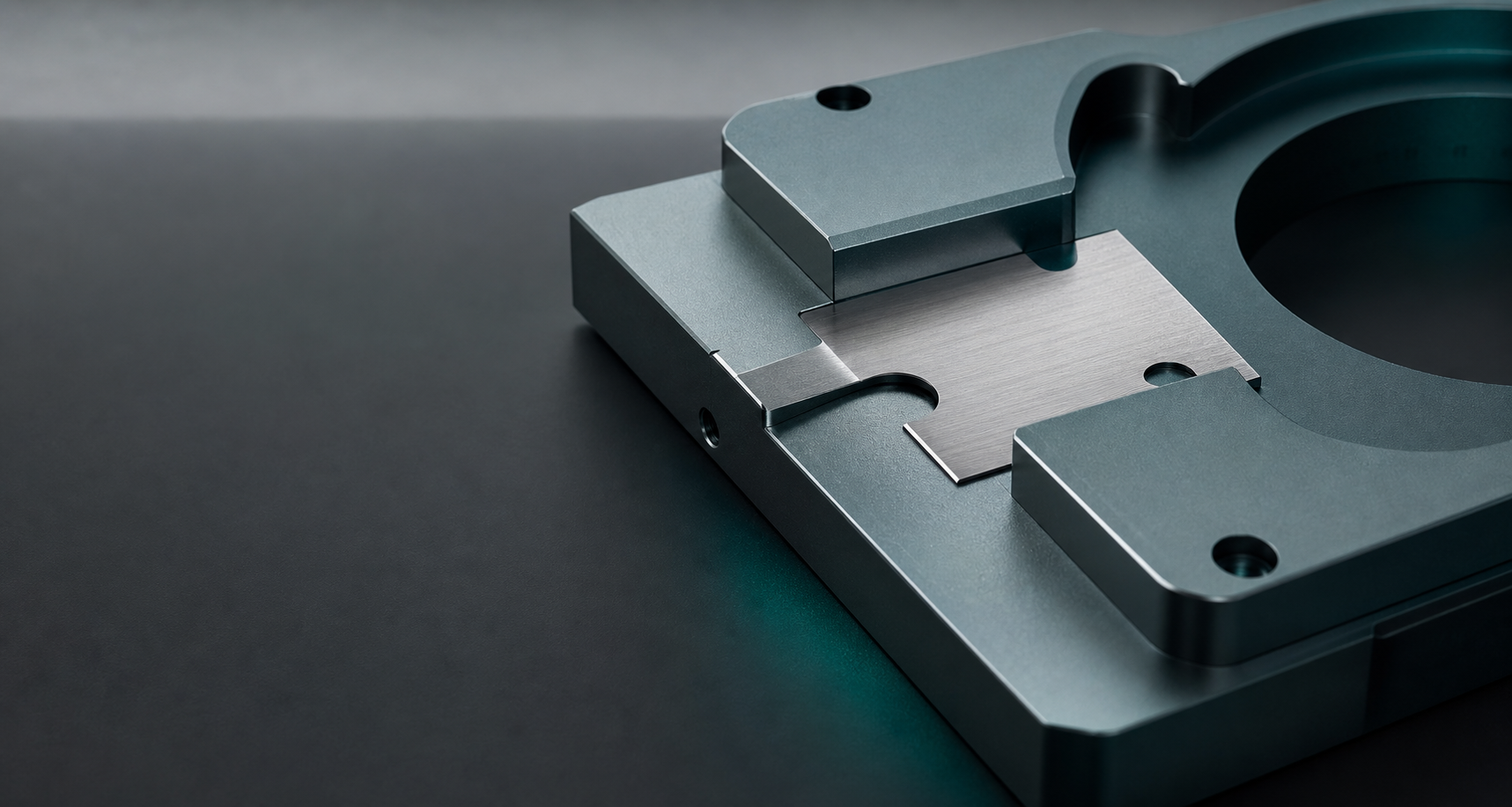 Precision-machined metal fixture on a graphite surface