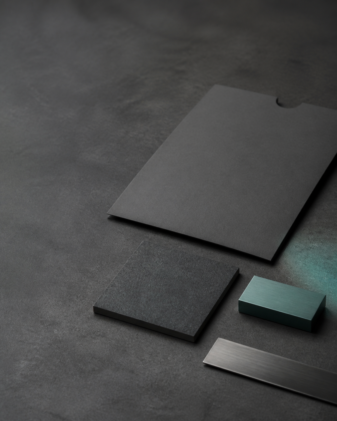 Blank evidence sleeve and industrial reference materials on a graphite work surface